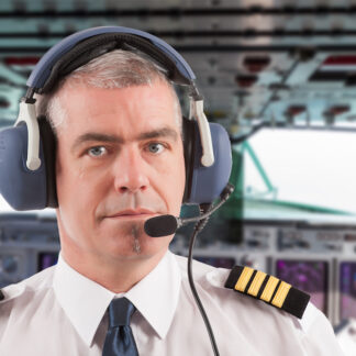 Airline,Pilot,Wearing,Uniform,With,Epaulettes,And,Headset,,On,Board